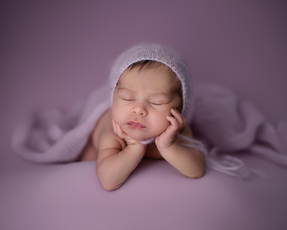 posed newborn baby girl in purple